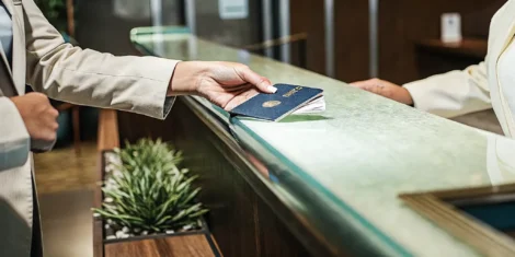 Traveler handing a passport to a document professional for expedited processing