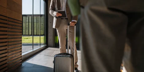 Traveler walking through a bright airport terminal, ready to depart on an international trip