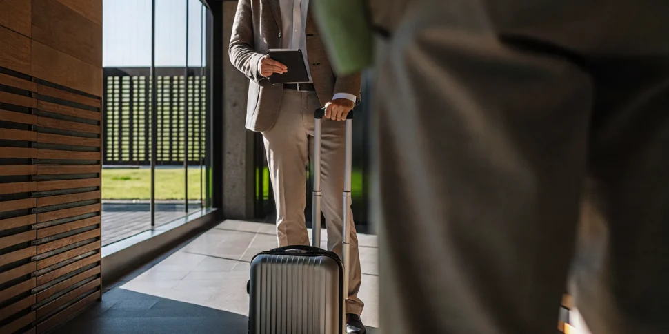 Traveler walking through a bright airport terminal, ready to depart on an international trip