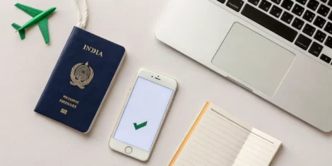 US passport, laptop, and toy airplane for an India visa for US citizens application.
